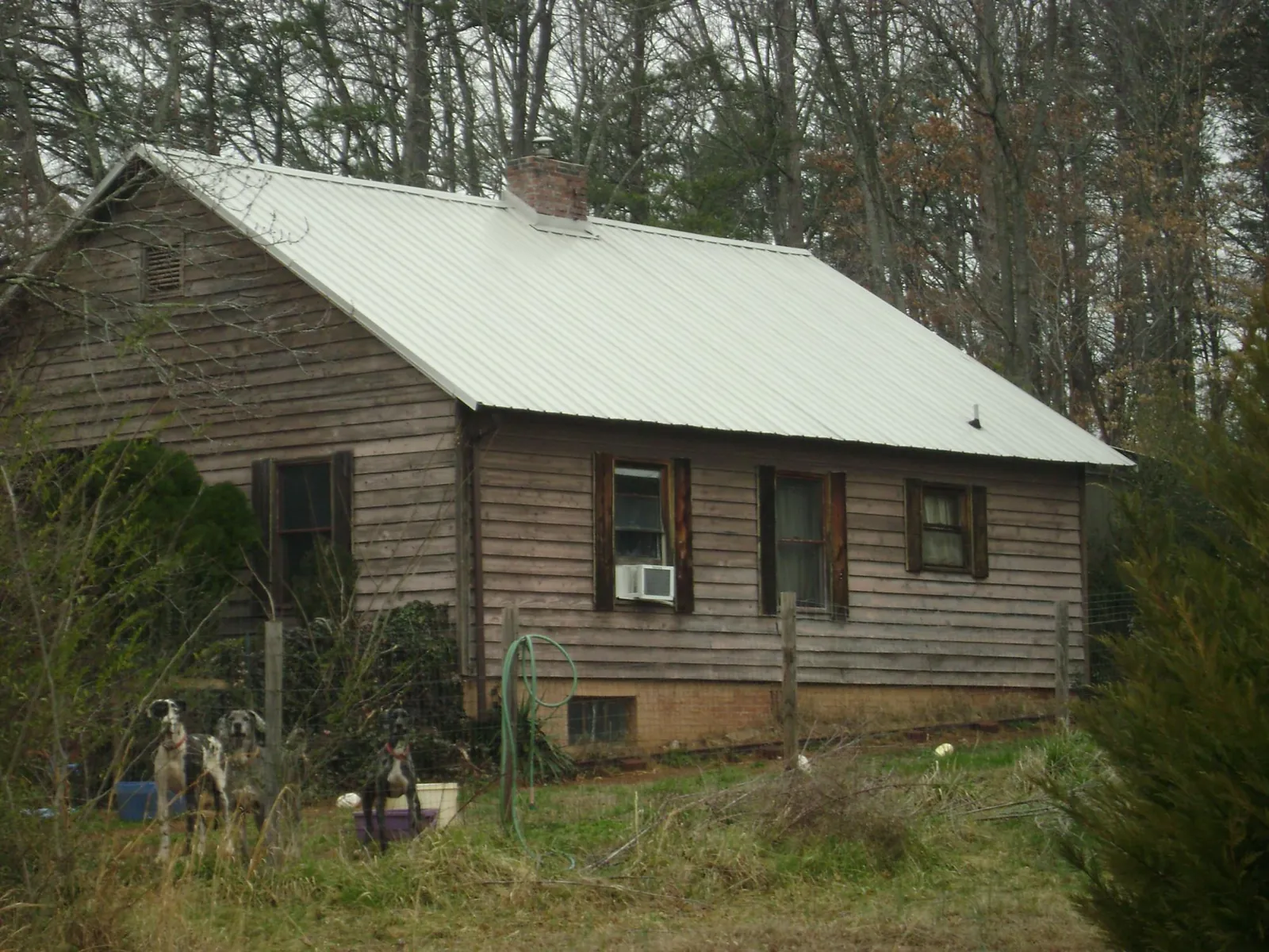 White metal roof on an old wood sided farmhouse, from a Metal Roof Installation job in Lavonia